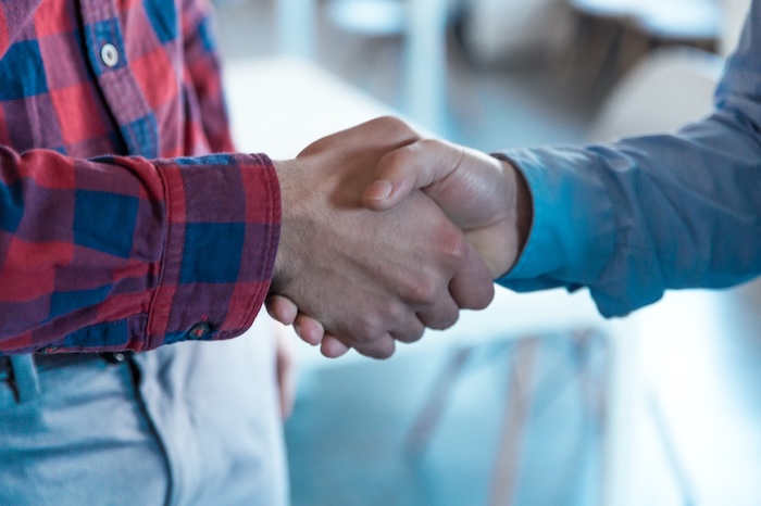 Service provider and client shaking hands. 