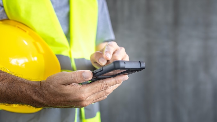 Service provider checking phone for new leads.