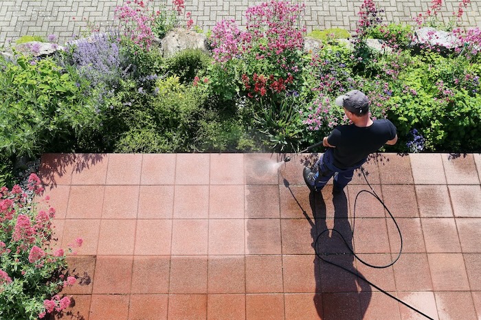 Power washing a concrete patio